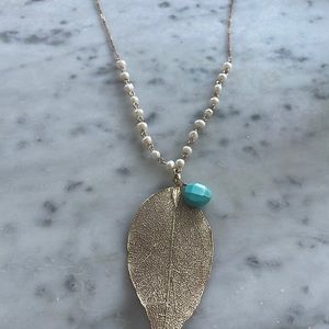 Long leaf-drop necklace with turquoise drop and other stones.